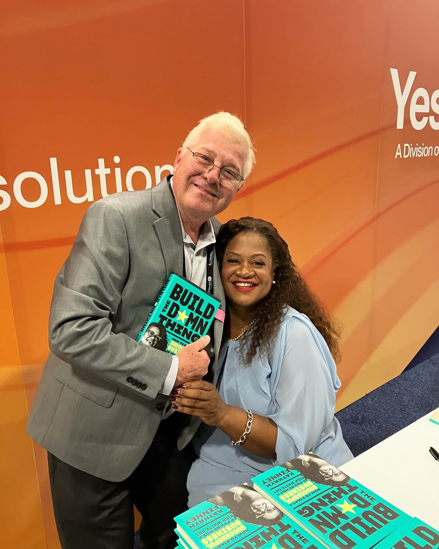 Kathryn Finney with a reader holding Build the Damn Thing